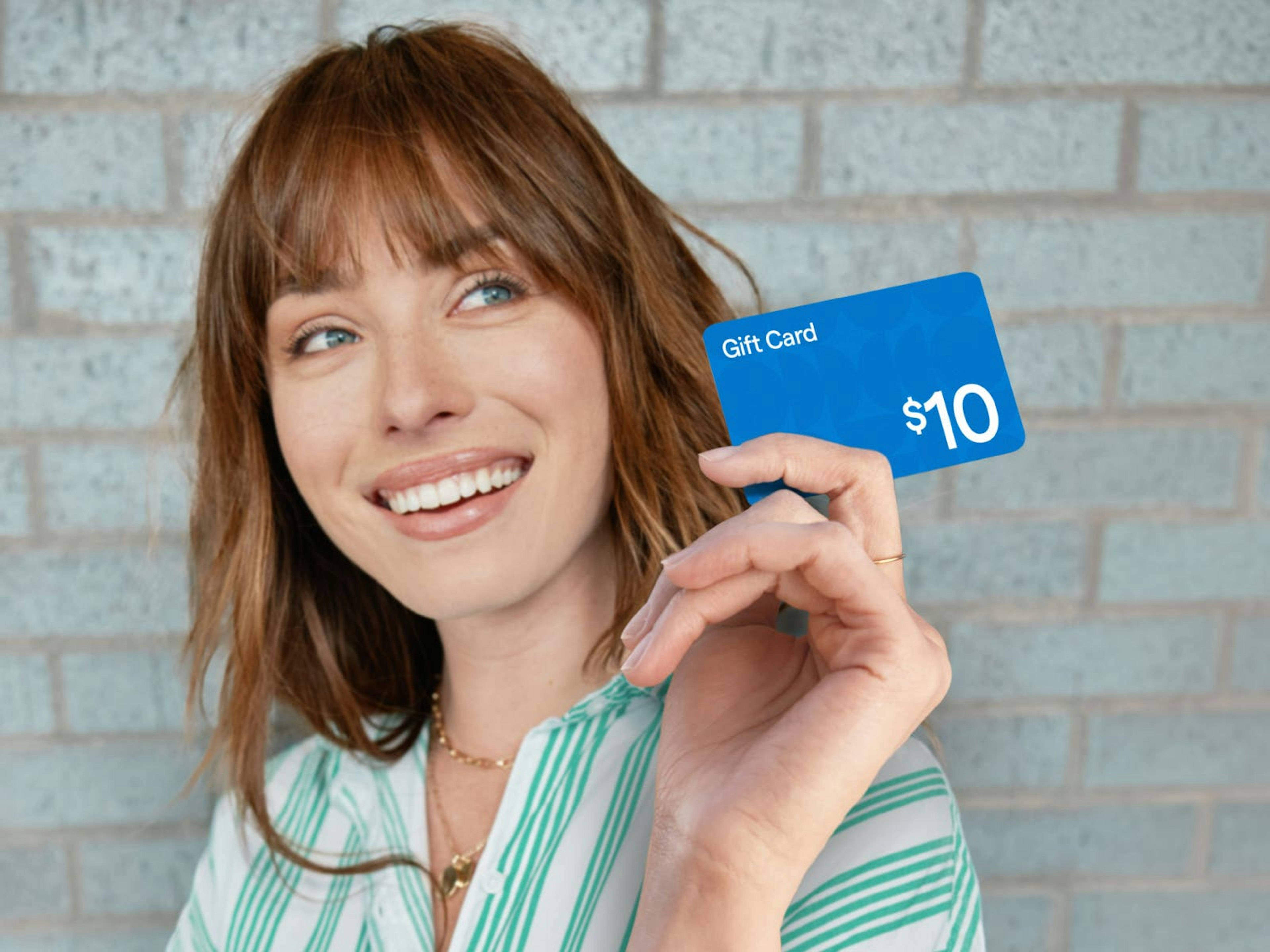 woman holding generic blue gift card